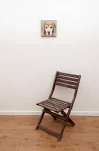 Pet portrait of a french bulldog by artist Erica Eriksdotter and a chair