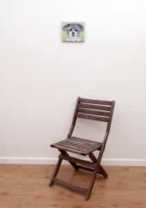 Pet portrait of a french bulldog by artist Erica Eriksdotter and a chair