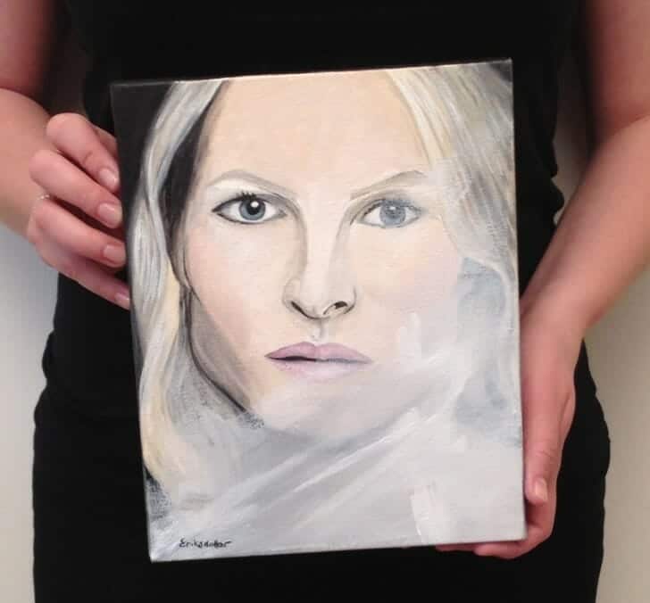 Erica Eriksdotter with the original painting, Woman and the Veil