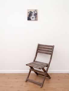 Pet portrait of a french bulldog by artist Erica Eriksdotter and a chair