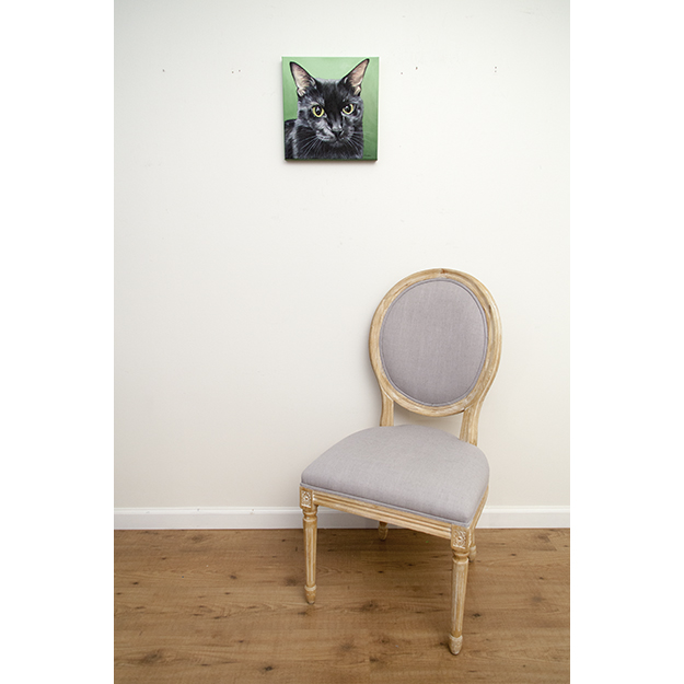 Minerva's original pet portrait of a black cat against a green background