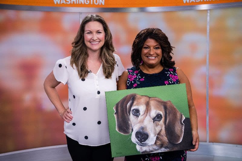 Fine arts painter Erica Eriksdotter and Julie Wright with her new pet portrait of her Beagle Bailey