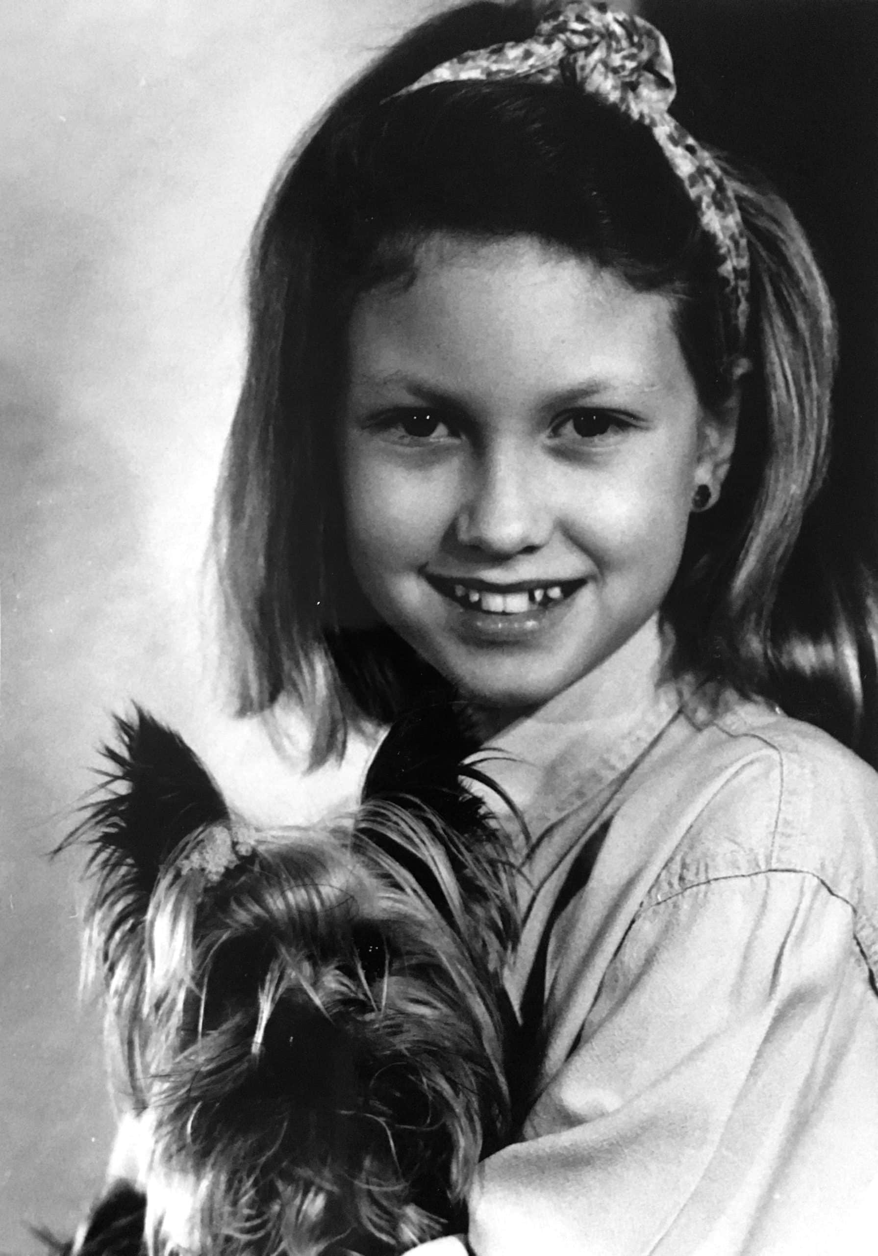 Young Erica Eriksdotter, future pet portrait artist, with her yorkie named Lucas