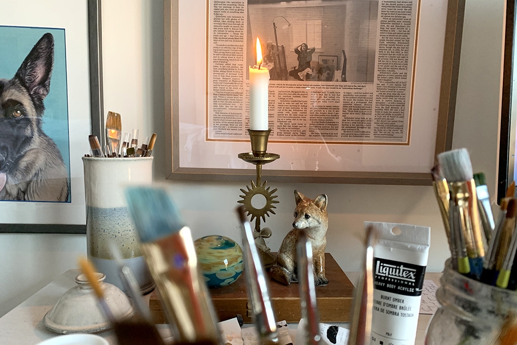 Candlelight in Erica Eriksdotter's art studio with brushes and paints